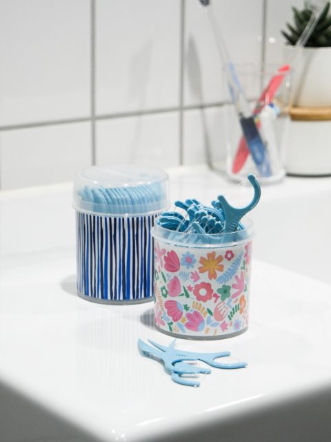 decorative flosser boxes on bathroom counter