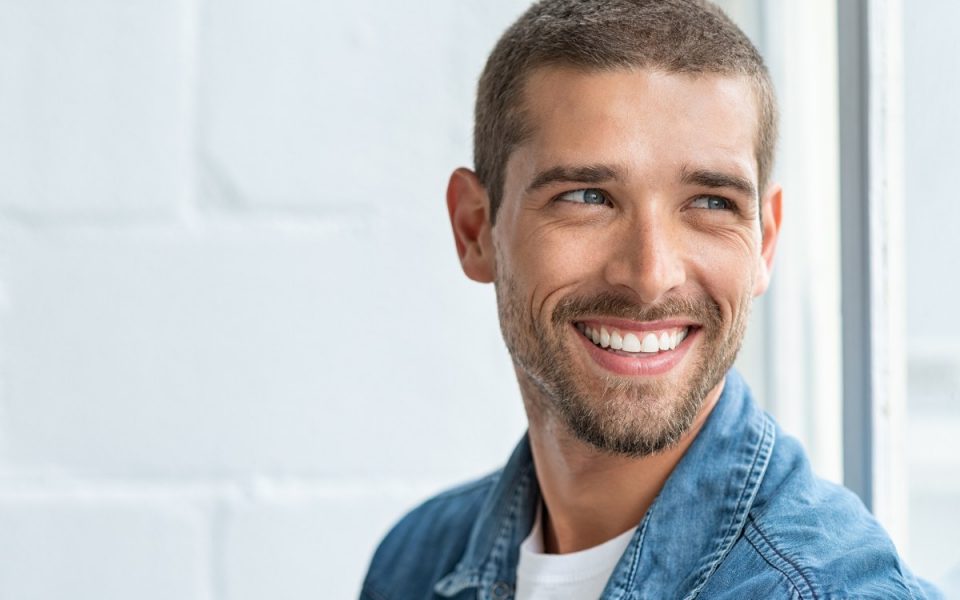 Man with white teeth smiling. 