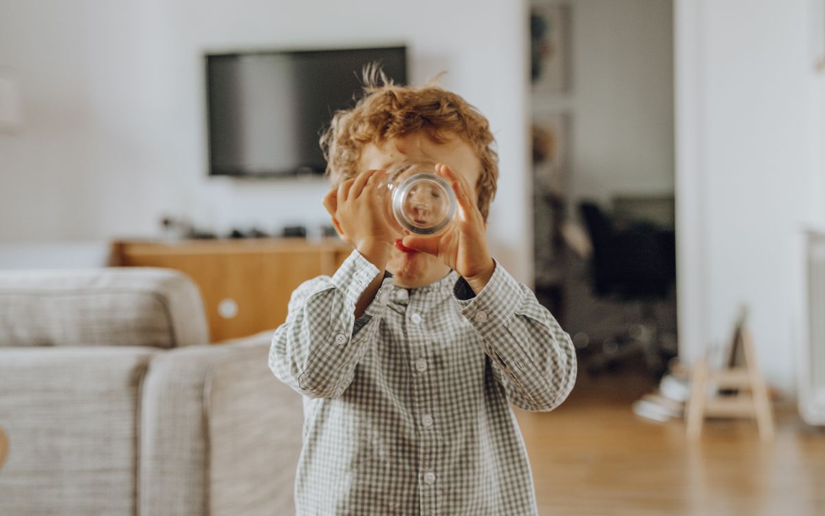 Child drinking from glass. 